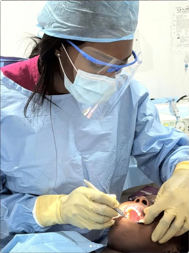 Dr Ogo Eze providing dental treatment to a patient at the clinic